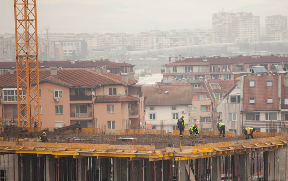 Workers at a city construction site with buildings in the background. Industrial urban development scene